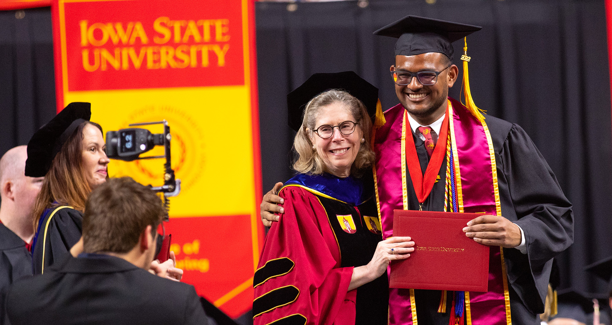 President Wendy Wintersteen poses with a graduate at commencement